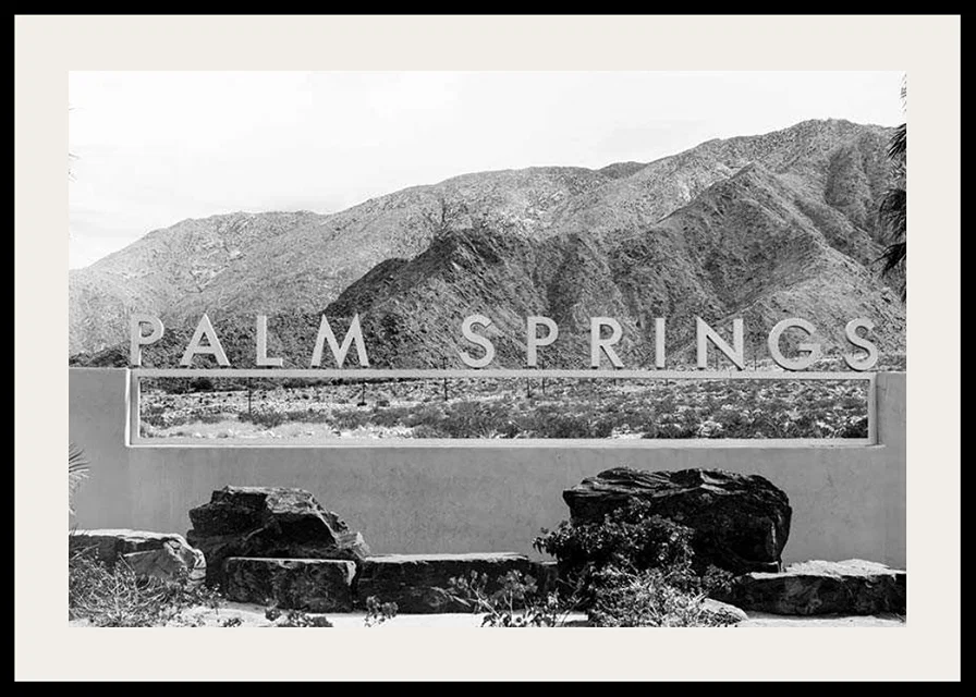 Black and white photo of Palm Springs sign with mountains in the background-12