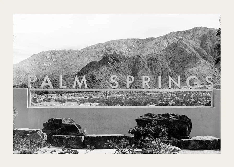 Black and white photo of Palm Springs sign with mountains in the background-12
