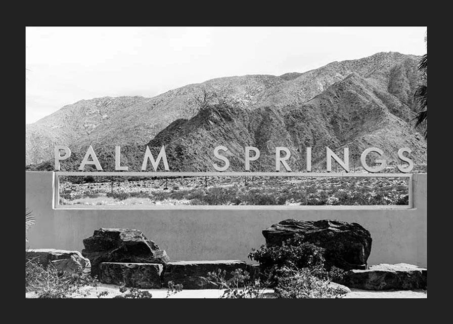Black and white photo of Palm Springs sign with mountains in the background-12