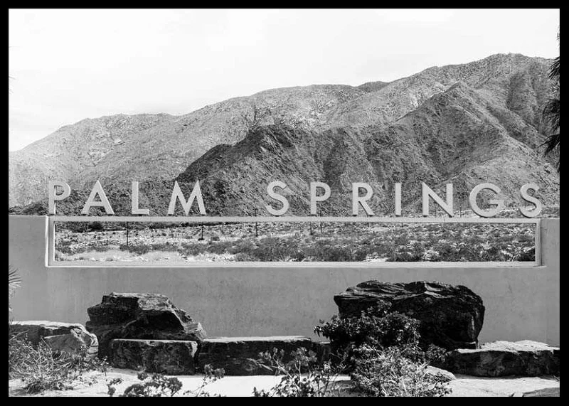 Black and white photo of Palm Springs sign with mountains in the background-12