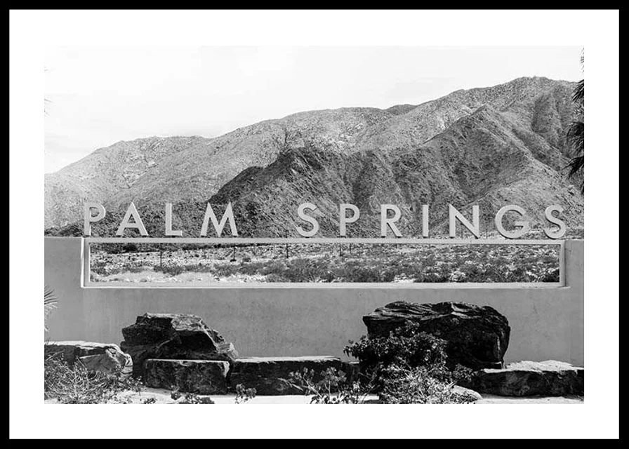 Black and white photo of Palm Springs sign with mountains in the background-12
