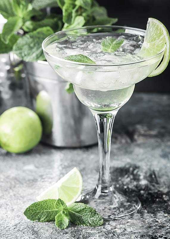 Photograph of margarita in glass with lime and mint leaves-12