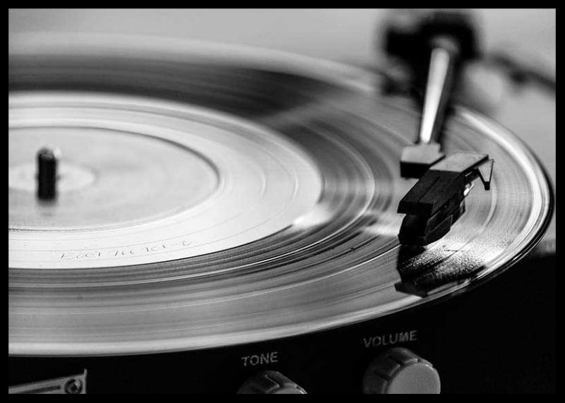 Black and white close-up of vinyl player with vinyl record on it-12