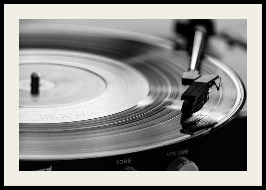 Black and white close-up of vinyl player with vinyl record on it-12