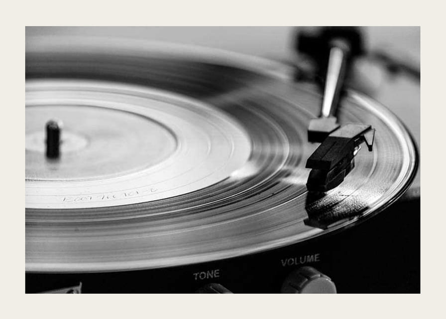 Black and white close-up of vinyl player with vinyl record on it-12