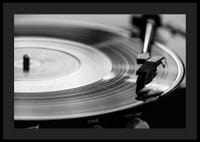 Black and white close-up of vinyl player with vinyl record on it-4