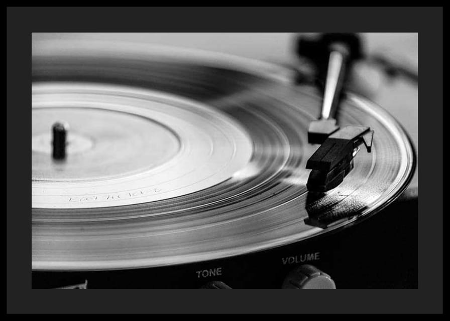 Black and white close-up of vinyl player with vinyl record on it-12