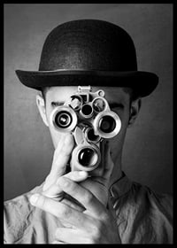 Black and white close-up of young man with hat and antique film camera-6