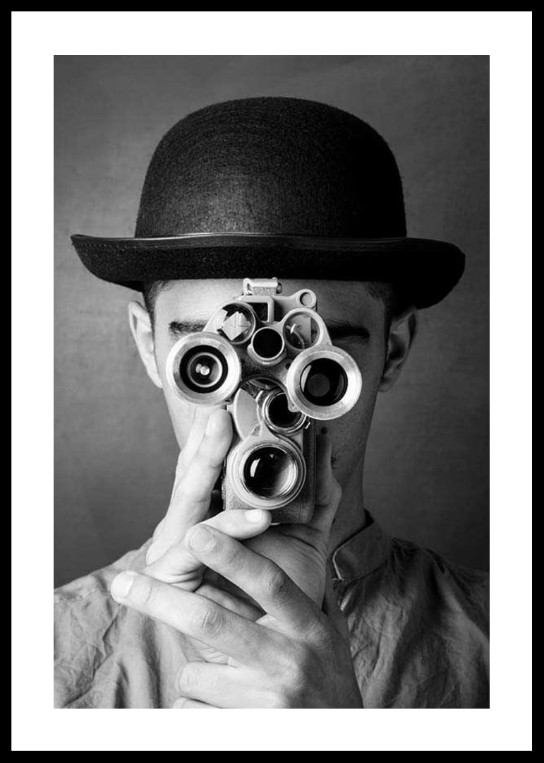 Black and white close-up of young man with hat and antique film camera-12
