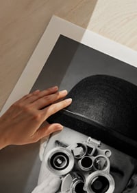 Black and white close-up of young man with hat and antique film camera-9