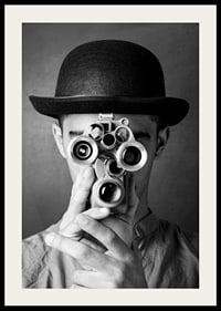 Black and white close-up of young man with hat and antique film camera-2