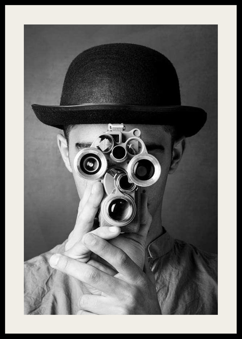 Black and white close-up of young man with hat and antique film camera-12