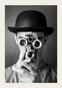 Black and white close-up of young man with hat and antique film camera-3