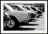 Black and white photography of classic cars in a row in a parking lot-2