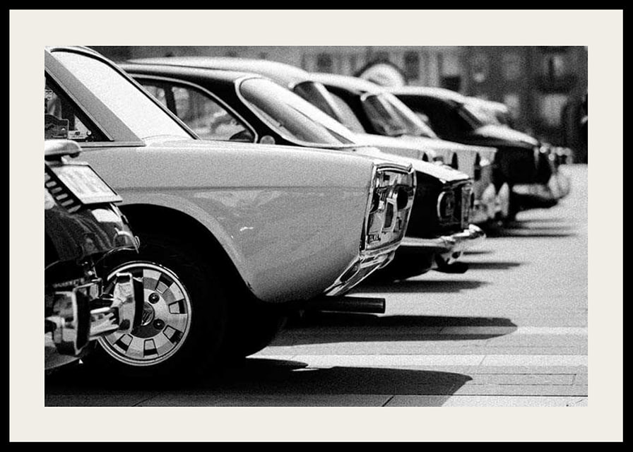 Black and white photography of classic cars in a row in a parking lot-12