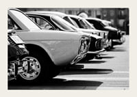 Black and white photography of classic cars in a row in a parking lot-3
