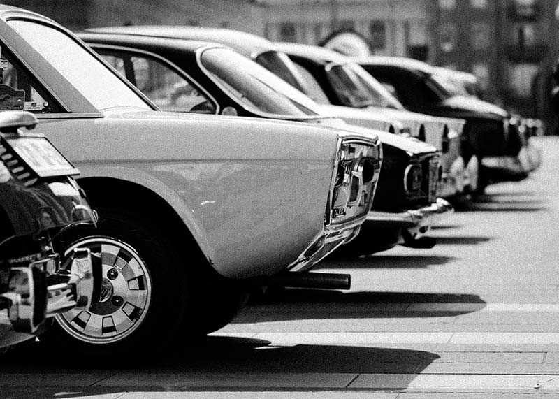 Black and white photography of classic cars in a row in a parking lot-12