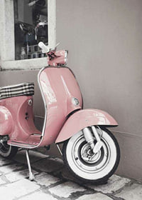 Photograph of pink Vespa scooter in retro style against wall-7