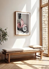 Photograph of pink Vespa scooter in retro style against wall-8