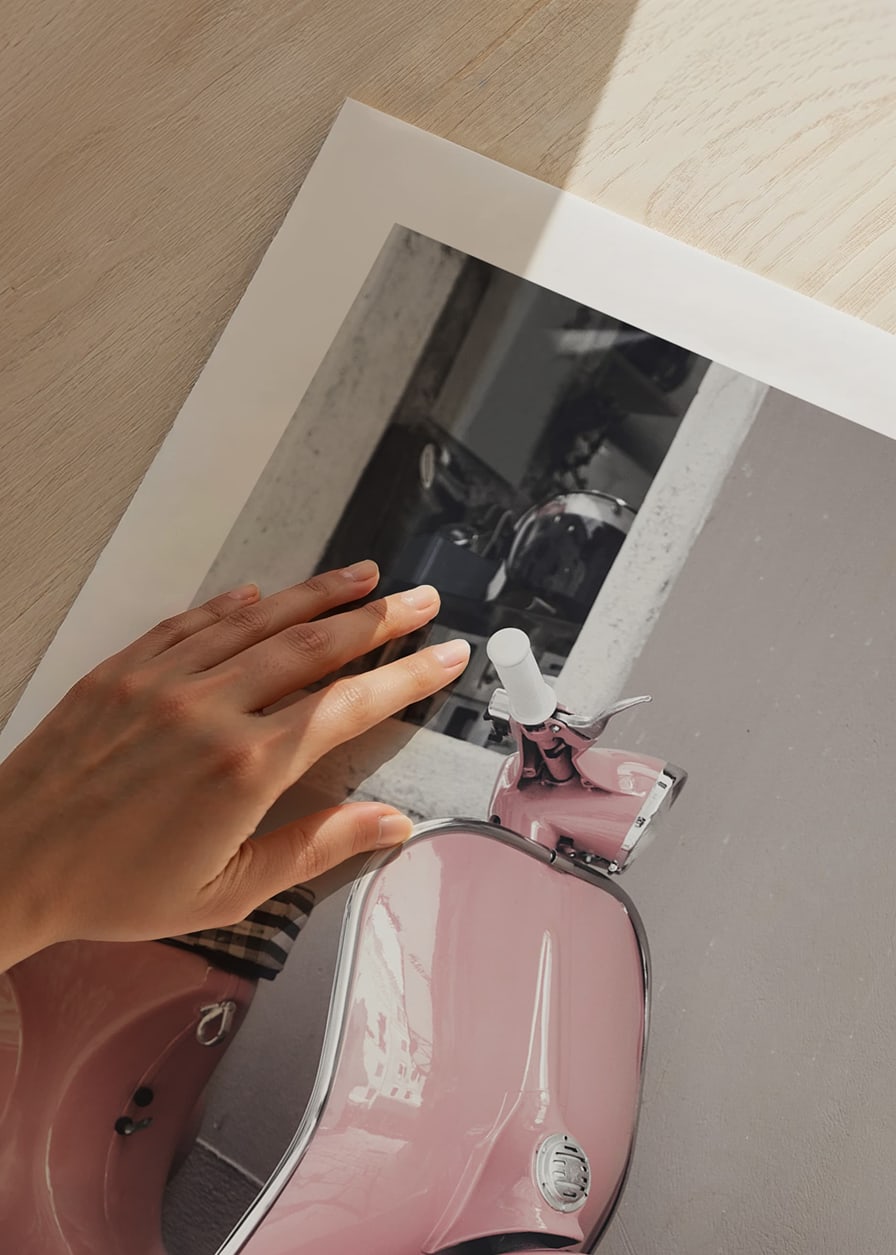 Photograph of pink Vespa scooter in retro style against wall-12
