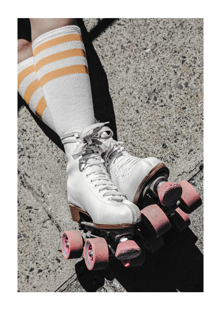 Photograph of white roller skates with pink wheels on asphalt-12