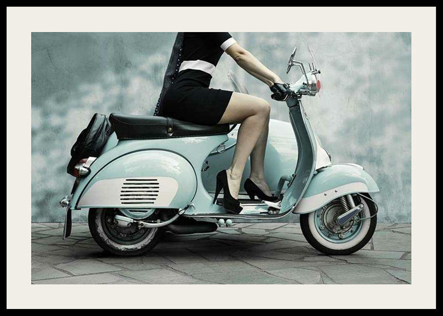 Photograph of woman on light blue retro scooter against gray wall-12