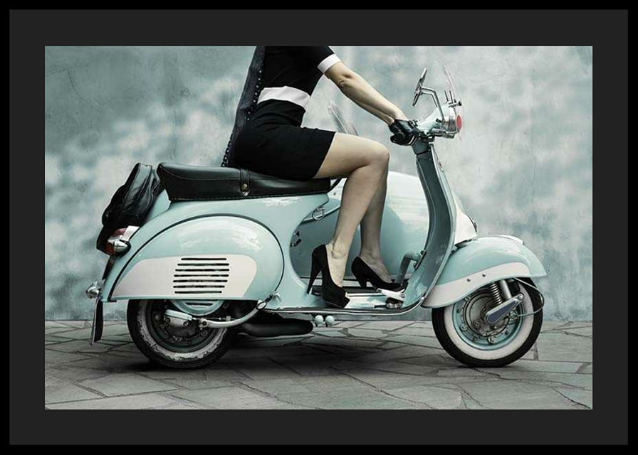 Photograph of woman on light blue retro scooter against gray wall-12