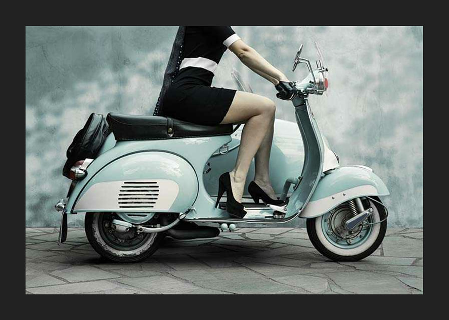 Photograph of woman on light blue retro scooter against gray wall-12