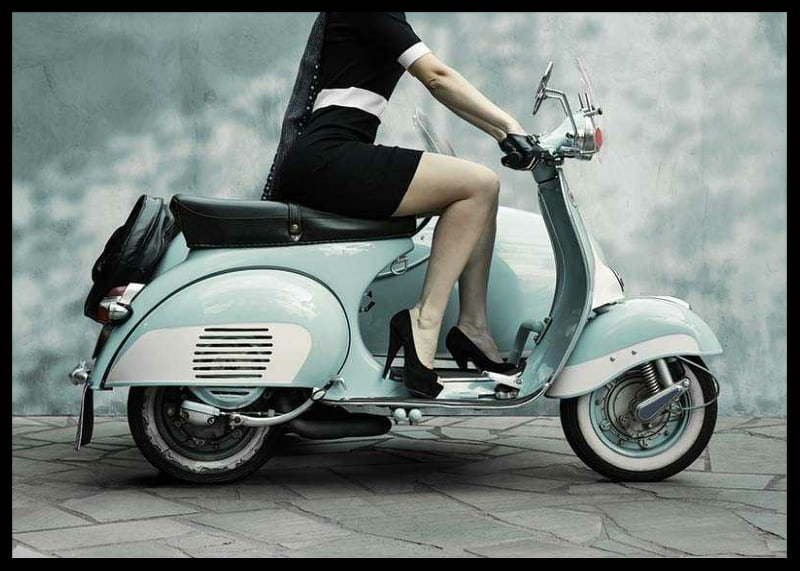 Photograph of woman on light blue retro scooter against gray wall-12