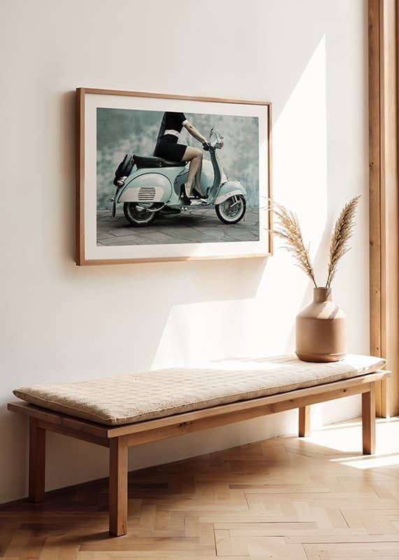 Photograph of woman on light blue retro scooter against gray wall-12