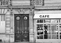 Black and white photo of classic Parisian cafe facade and gate-7