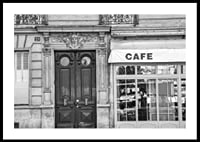 Black and white photo of classic Parisian cafe facade and gate-0