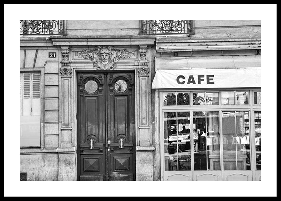 Black and white photo of classic Parisian cafe facade and gate-12