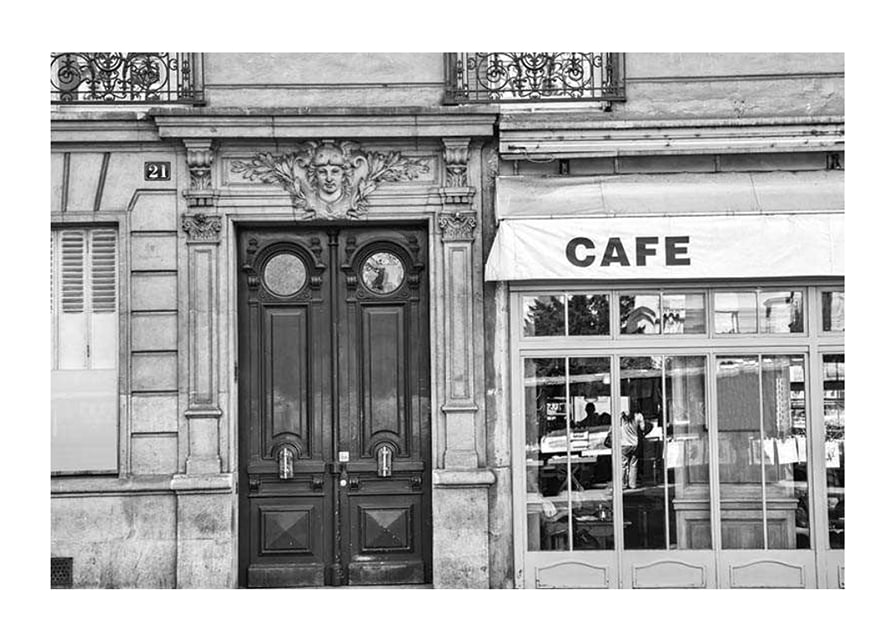 Black and white photo of classic Parisian cafe facade and gate-12