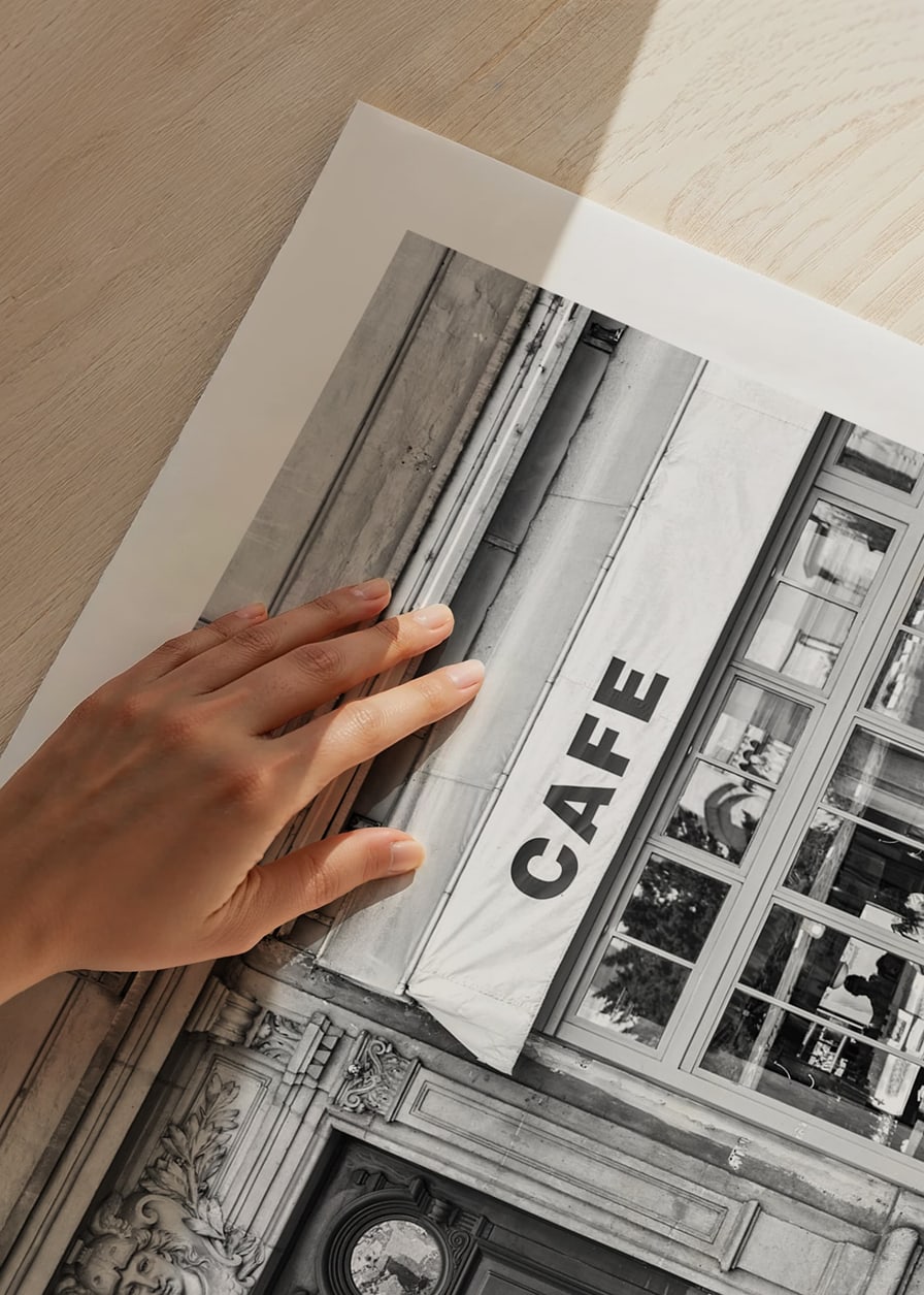 Black and white photo of classic Parisian cafe facade and gate-12