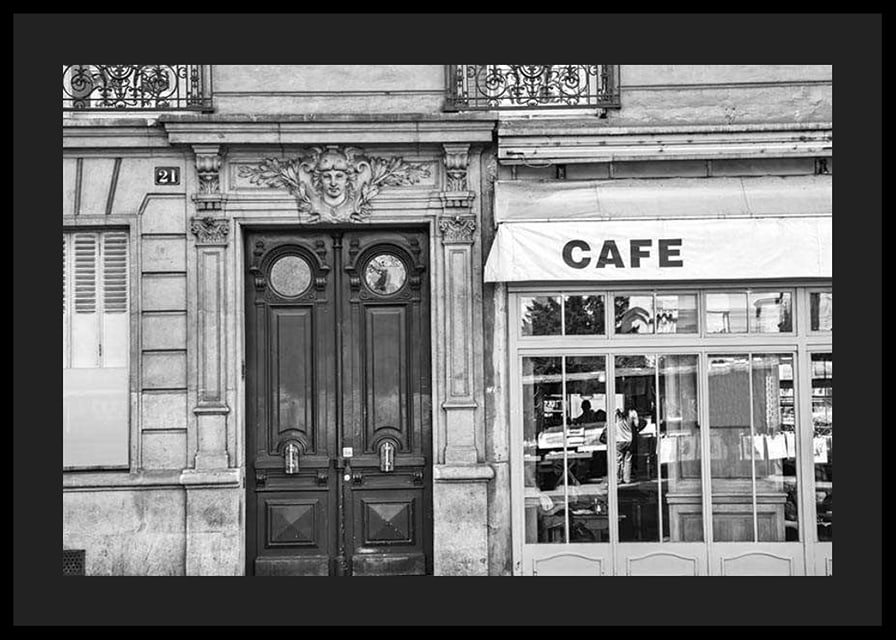 Black and white photo of classic Parisian cafe facade and gate-12