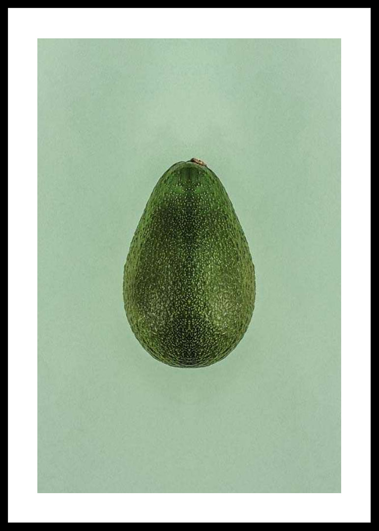 Photograph of whole green avocado against a solid green background-12