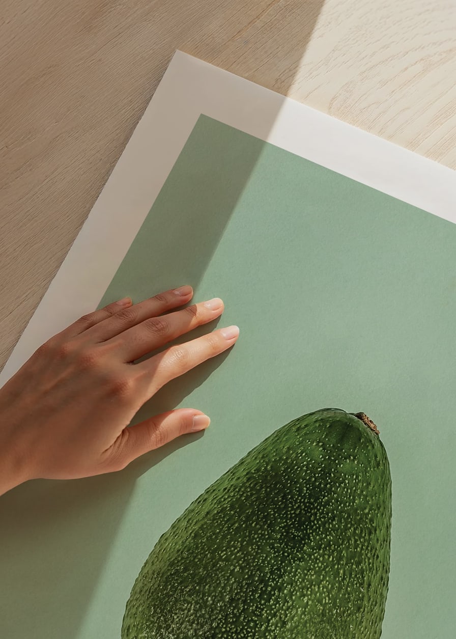 Photograph of whole green avocado against a solid green background-12