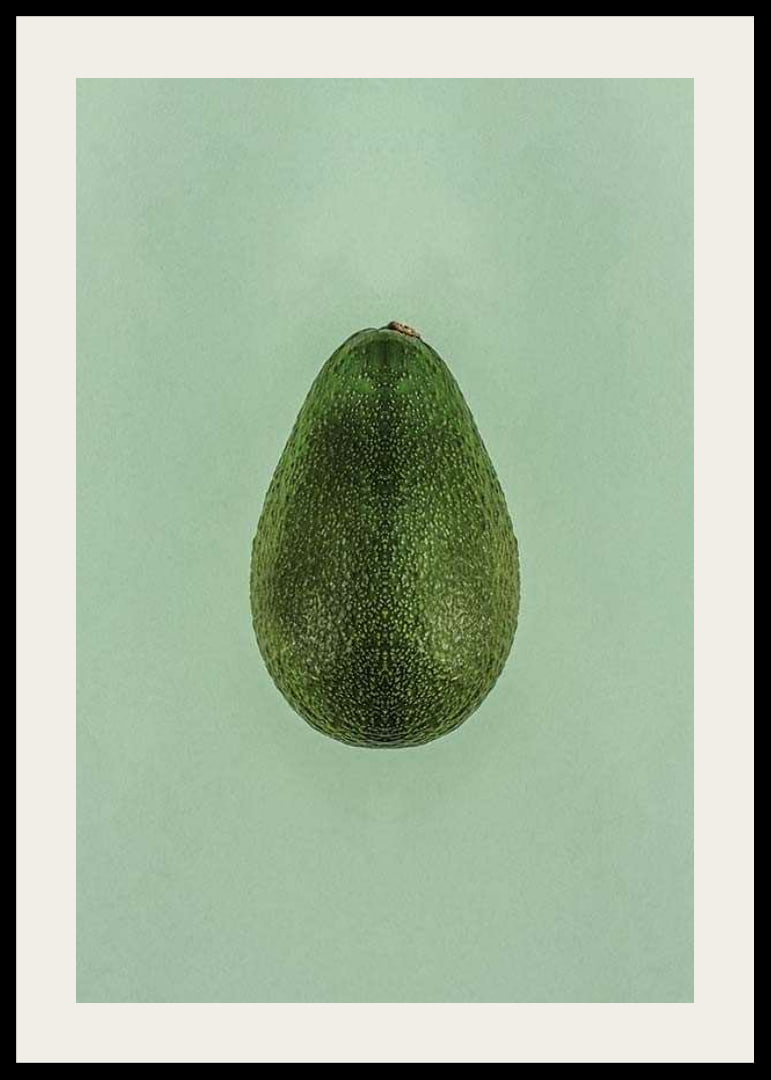Photograph of whole green avocado against a solid green background-12