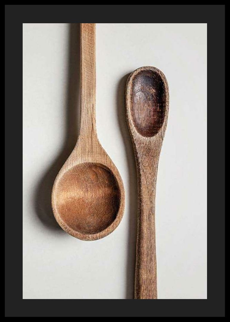 Two wooden spoons in close-up against light gray background, photographic-12