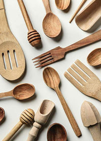 Photograph of various wooden kitchen utensils against a light background-7
