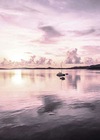 Photograph of sailboat on calm sea with purple sunset-7