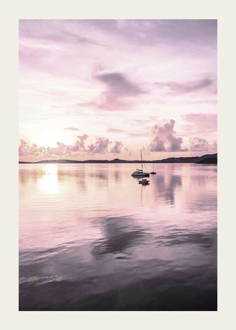 Photograph of sailboat on calm sea with purple sunset-12