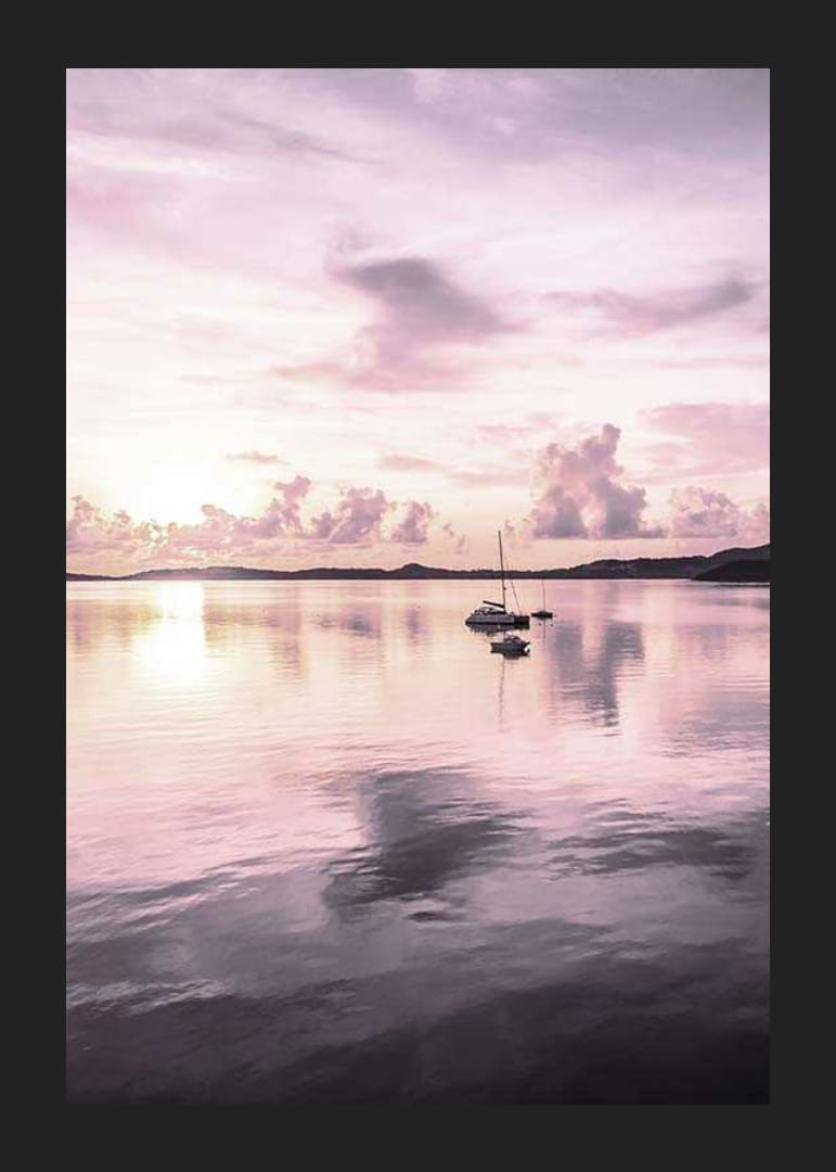 Photograph of sailboat on calm sea with purple sunset-12