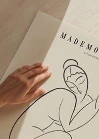 Abstrakt linjeteckning av sittande kvinna i svart på beige-3
