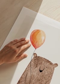 Illustrated brown bear with orange balloon on light background-9