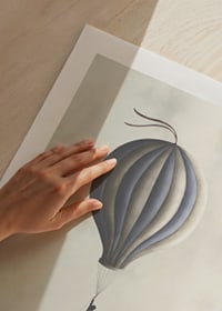 Illustration of man hanging from hot air balloon in muted tones-9