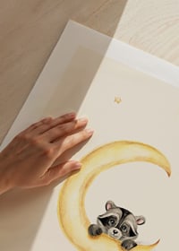 Watercolor illustration of raccoon hanging on a yellow moon-9