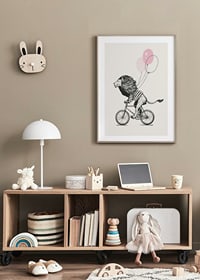 Illustrated lion with striped shirt riding a bike with pink balloons-8