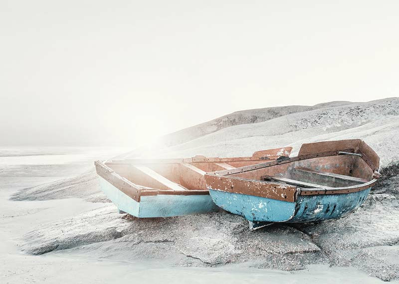 Photograph of two worn wooden boats on a light cliff-12
